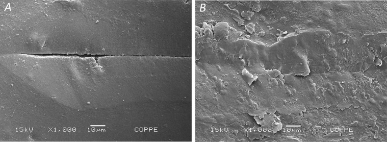 Figure 5. Photomicrographs of scratches formed on the samples after scratch tests. (A) Cracks on the OM group and (B) debris on the TP group. Original magnification at 100×.