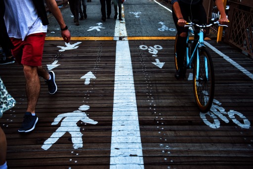 Photograph of pedestrians and bicyclists traveling on a shared-use lane