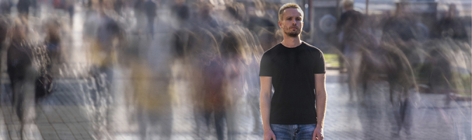 Man standing alone in a crowd