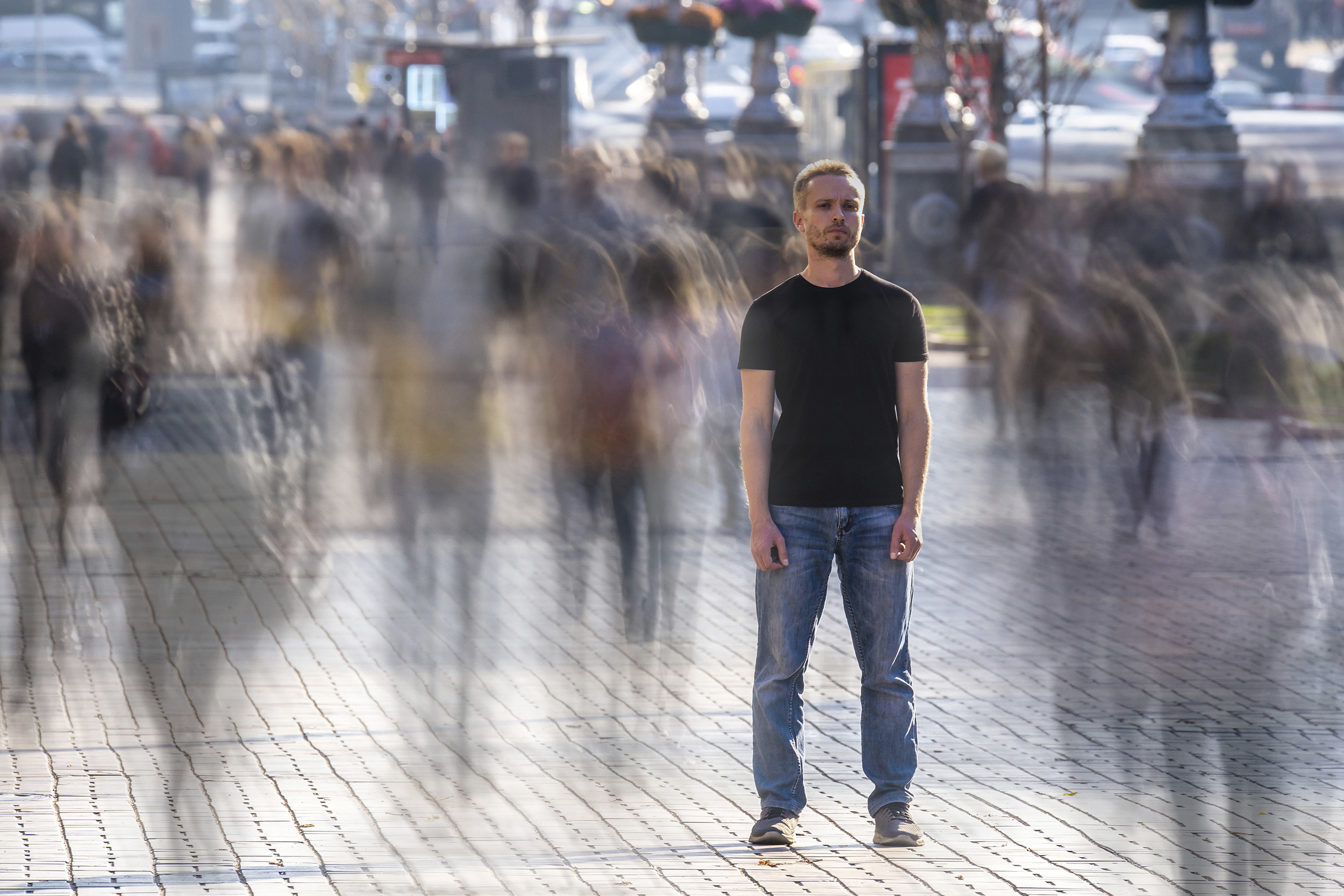 Man standing alone in a crowd