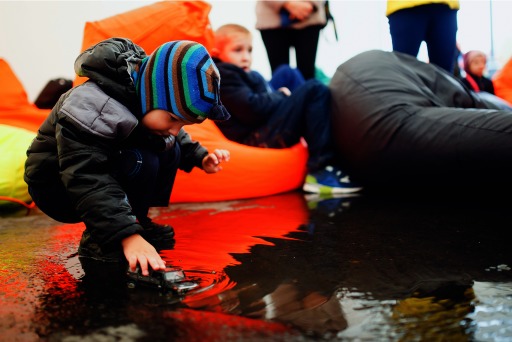 Photograph of a child playing in a puddle of rainwater after Hurricane Harvey