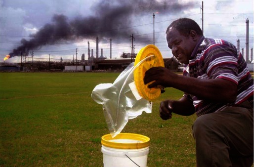 Photograph of a man using a bucket sampler.