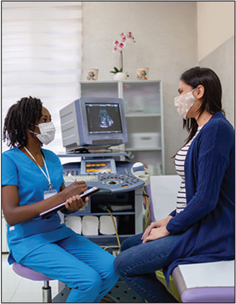 African-American female doctor doing gynecological examination