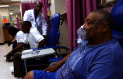 Photograph of three adults receiving treatment for asthma attacks at an Atlanta emergency room