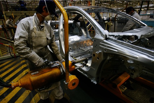 Photograph of workers in a Chinese car factory