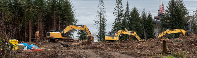 Three excavator trucks digging soil.