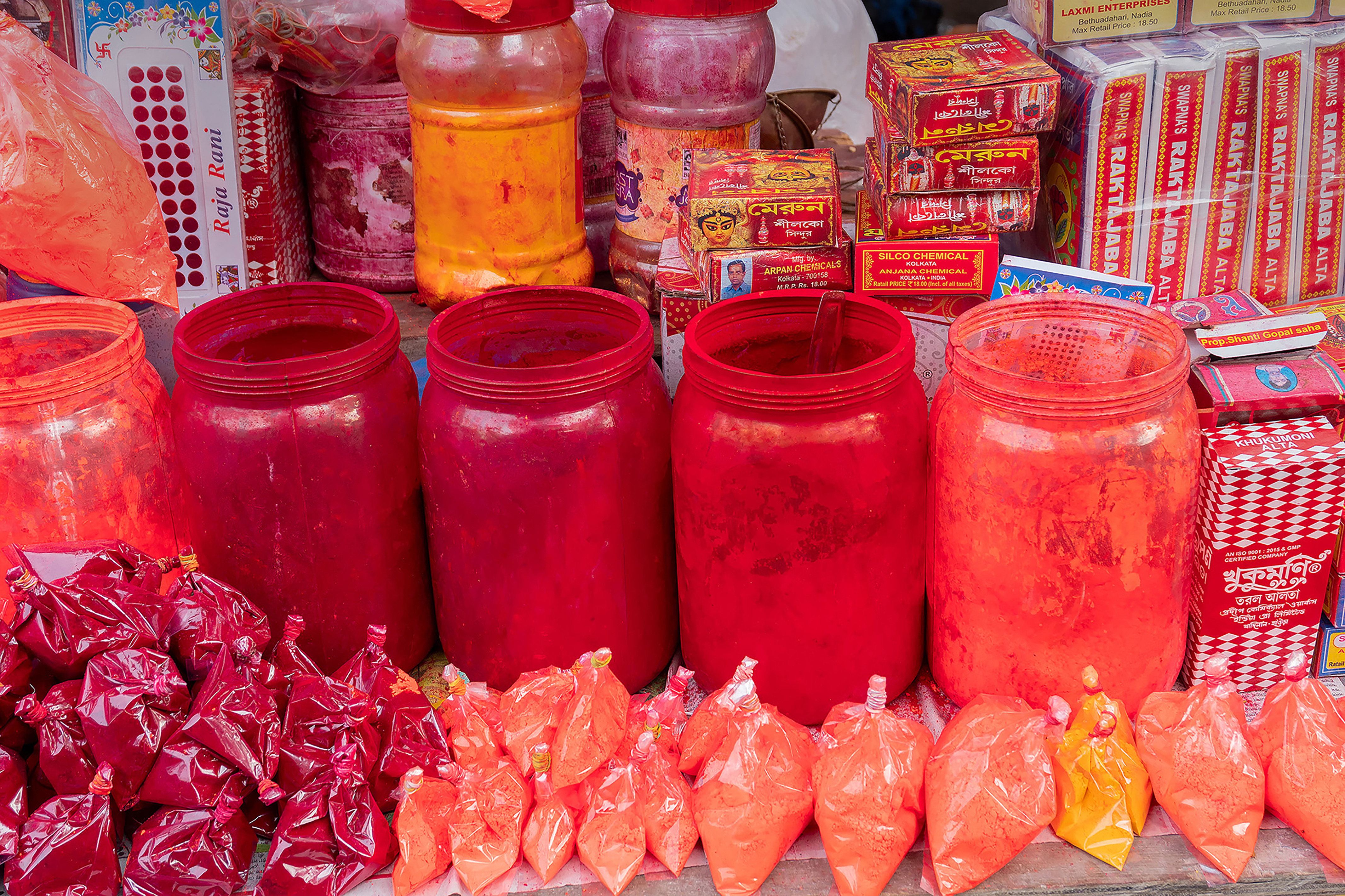 Jars and packets of bright red and orange sindoor