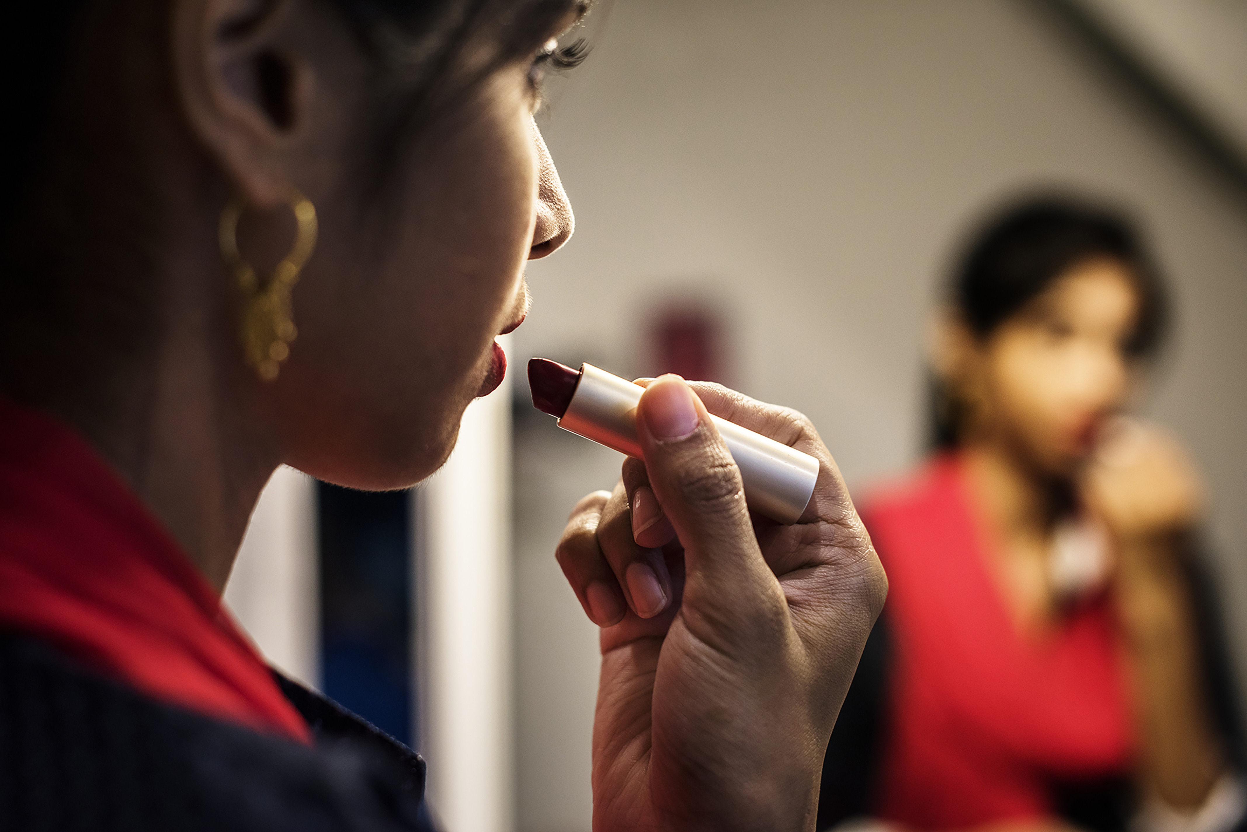 A woman applying lipstick