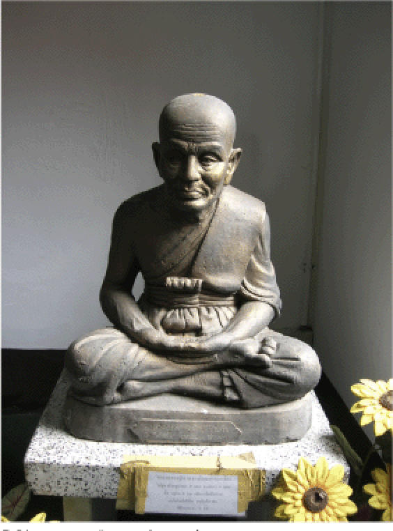 Statues of monks, like this figure at Wat U Mong Klang Wiang, are common sites for Thai Buddhists' offerings