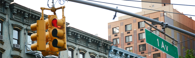 Traffic light with apartment buildings behind it