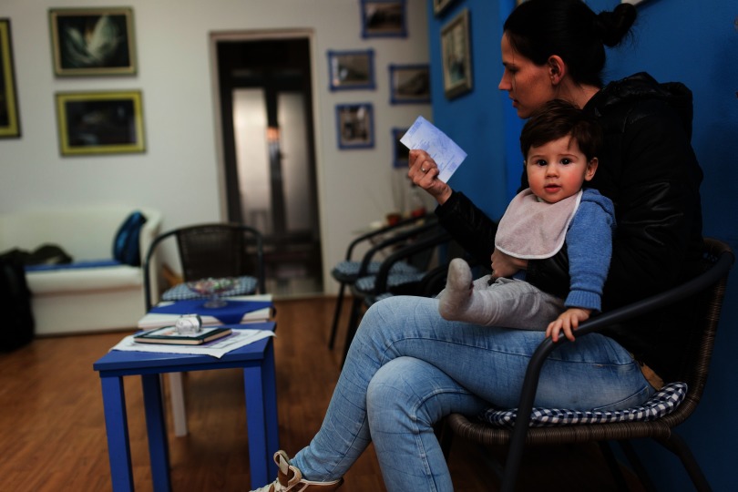 Photograph of a woman and her young son in a doctor’s waiting room.