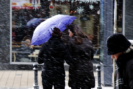 Photograph of women on a city street during an icy cold storm